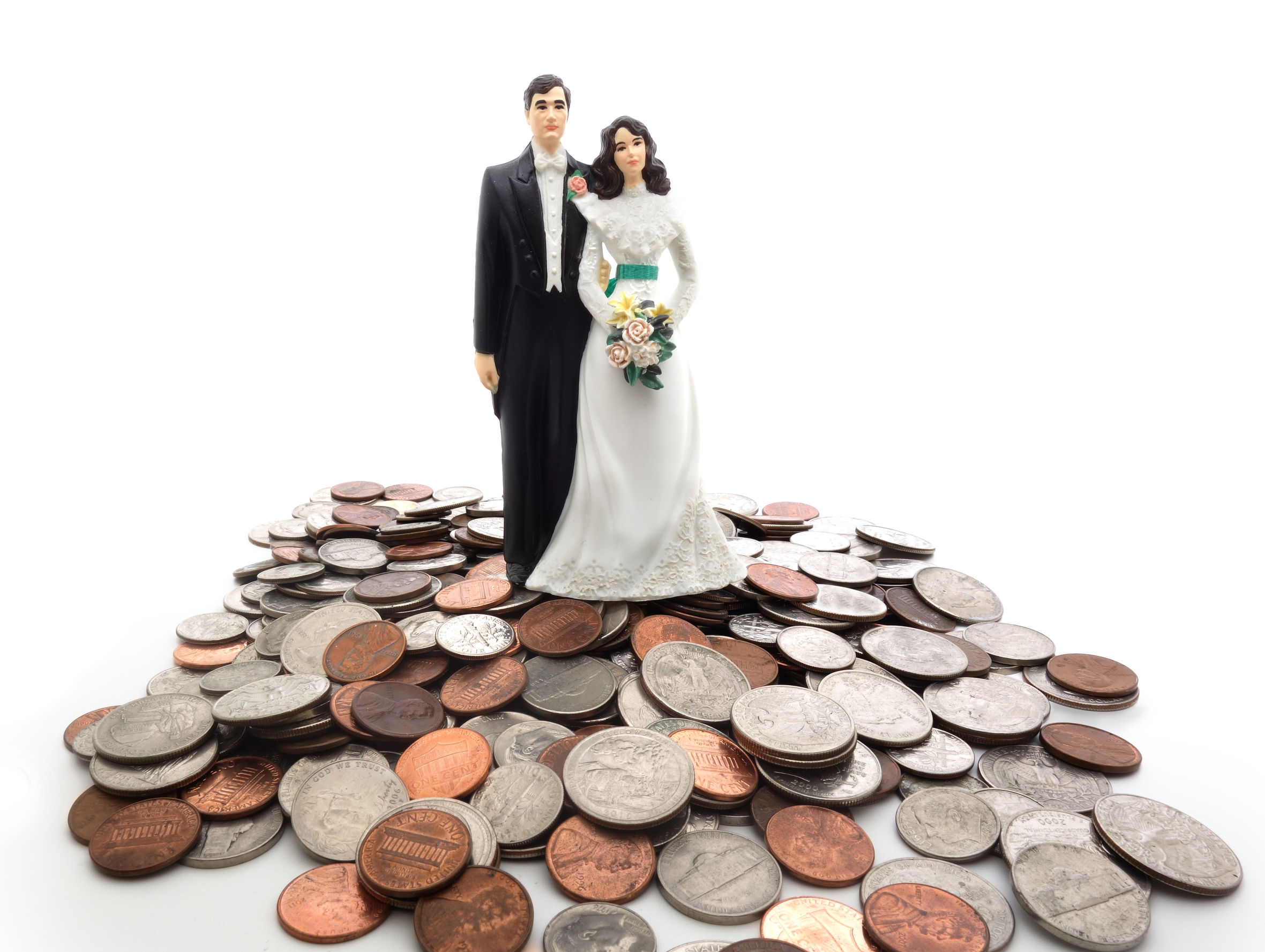 27699301 - plastic wedding couple on a pile of coins - money concept
